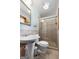 Neutral bathroom featuring a glass enclosed shower, pedestal sink, tiled walls and trim at 25 Hickory Dr, Stockbridge, GA 30281