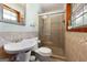 Neutral bathroom featuring a glass enclosed shower, pedestal sink, tiled walls and trim at 25 Hickory Dr, Stockbridge, GA 30281