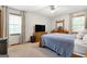 Bright bedroom with carpet floors, a ceiling fan, and two large windows at 25 Hickory Dr, Stockbridge, GA 30281