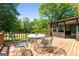 Exterior view of the home's wooden deck with metal patio table and chairs at 25 Hickory Dr, Stockbridge, GA 30281