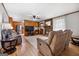 Cozy living room with hardwood floors, a stone fireplace, and access to the kitchen at 25 Hickory Dr, Stockbridge, GA 30281