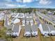 An aerial view shows an expansive layout of homes in a community with street access and natural green space at 1393 Halpern Nw Ln, Kennesaw, GA 30144