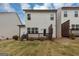 Backyard view featuring the home's siding, deck, and small lawn at 1393 Halpern Nw Ln, Kennesaw, GA 30144