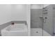 Modern bathroom featuring a separate soaking tub and glass-enclosed shower with stylish gray tiling at 1393 Halpern Nw Ln, Kennesaw, GA 30144