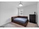Bedroom featuring a modern bed, neutral decor, and natural light at 1393 Halpern Nw Ln, Kennesaw, GA 30144
