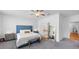 Inviting bedroom features a blue upholstered headboard, a seating bench, and a view of the en-suite bathroom at 1393 Halpern Nw Ln, Kennesaw, GA 30144