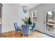 Bright dining area with stylish blue chairs, a glass table, and access to an outdoor patio at 1393 Halpern Nw Ln, Kennesaw, GA 30144