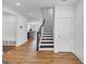 Inviting foyer with hardwood floors, staircase, and open view to the kitchen, offering a bright entrance at 1393 Halpern Nw Ln, Kennesaw, GA 30144