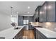 This contemporary kitchen offers stainless steel appliances, gray cabinets, and an island with a sink at 1393 Halpern Nw Ln, Kennesaw, GA 30144