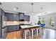 Modern kitchen featuring gray cabinets, quartz countertops, stainless steel appliances, and island with seating at 1393 Halpern Nw Ln, Kennesaw, GA 30144