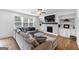 Spacious living room with a fireplace, built-in shelving, and large windows for ample natural light at 1393 Halpern Nw Ln, Kennesaw, GA 30144