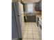 Functional kitchen with white appliances, neutral cabinets, tile floors, and window at 3244 Abbeywood Dr, Decatur, GA 30034