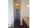 Bathroom featuring granite countertops, vanity with double sinks, and a hallway to a walk-in closet at 114 Revere Turn, Fairburn, GA 30213