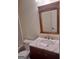 Bathroom featuring a marble countertop, wooden vanity, and a framed mirror above the sink at 114 Revere Turn, Fairburn, GA 30213