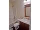 Bathroom featuring tub, toilet and sink with wood mirror and vanity at 114 Revere Turn, Fairburn, GA 30213