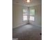 Carpeted bedroom with natural light streaming through two windows at 114 Revere Turn, Fairburn, GA 30213