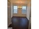 Bright dining room with dark floors, chandelier, and natural light from two windows at 114 Revere Turn, Fairburn, GA 30213