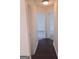 Hallway showcasing doors to multiple rooms and stylish flooring at 114 Revere Turn, Fairburn, GA 30213