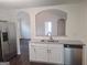 Elegant kitchen with stainless steel appliances, granite countertops, white cabinets, and a modern dishwasher at 114 Revere Turn, Fairburn, GA 30213