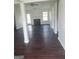 A spacious living room boasts dark wood floors, a fireplace, and plenty of natural light from windows and a glass door at 114 Revere Turn, Fairburn, GA 30213