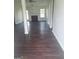 Expansive living room featuring dark wood floors, a cozy fireplace, and an abundance of natural light at 114 Revere Turn, Fairburn, GA 30213