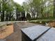 Spacious backyard with a covered pool and hot tub area, surrounded by lush trees at 525 Brooksdale Dr, Woodstock, GA 30189