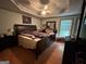 Large main bedroom with tray ceilings, a ceiling fan, and a window at 525 Brooksdale Dr, Woodstock, GA 30189