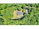 Expansive aerial view of the home nestled within a lush forest, showcasing its serene and private setting at 335 Winding Stream Trl, Hampton, GA 30228