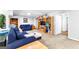 Spacious basement living room featuring comfortable seating, built-in bookshelves, and neutral carpeting at 335 Winding Stream Trl, Hampton, GA 30228