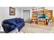 Basement Gathering room with built-in bookshelves and a comfortable sofa at 335 Winding Stream Trl, Hampton, GA 30228