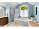 Bathroom with a soaking tub, walk-in shower, and wood vanity at 335 Winding Stream Trl, Hampton, GA 30228