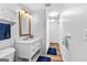 Bathroom features a white vanity with drawers and a large mirror with unique lighting at 335 Winding Stream Trl, Hampton, GA 30228