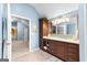 Bathroom with wood vanity and view into the bedroom area at 335 Winding Stream Trl, Hampton, GA 30228