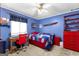 Charming blue bedroom featuring a cozy twin bed, study desk, and airplane decor at 335 Winding Stream Trl, Hampton, GA 30228