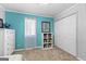 Bedroom featuring turquoise accent wall and white furniture at 335 Winding Stream Trl, Hampton, GA 30228