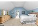 Cozy bedroom with blue walls, plush carpeting, and a doorway to the en suite at 335 Winding Stream Trl, Hampton, GA 30228