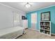 Bright bedroom with fresh blue accents, natural light, and carpet flooring at 335 Winding Stream Trl, Hampton, GA 30228