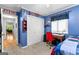 Blue bedroom with a window for natural light and carpet flooring at 335 Winding Stream Trl, Hampton, GA 30228