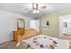 Cozy bedroom with wood furniture and a quilt on the bed, brightened by natural light at 335 Winding Stream Trl, Hampton, GA 30228