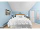Bedroom with light blue walls, neutral carpet, and stylish decor at 335 Winding Stream Trl, Hampton, GA 30228