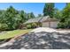 Beautiful home with a detached garage, lush landscaping, and paved driveway leading to the street at 335 Winding Stream Trl, Hampton, GA 30228
