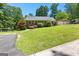 Quaint ranch-style home with a detached garage, mature landscaping, and a circular driveway at 335 Winding Stream Trl, Hampton, GA 30228