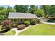 Beautiful ranch-style home with a detached two-car garage, mature trees, and manicured landscaping at 335 Winding Stream Trl, Hampton, GA 30228