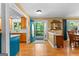 Bright foyer with wood floors, view of the front porch through an oval glass door, and views into kitchen and dining room at 335 Winding Stream Trl, Hampton, GA 30228