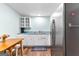 Galley kitchen with white cabinets, stainless steel refrigerator, and light blue walls at 335 Winding Stream Trl, Hampton, GA 30228