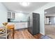 View of the kitchen that features stainless steel refrigerator, white cabinets, and wooden flooring at 335 Winding Stream Trl, Hampton, GA 30228