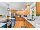Bright kitchen featuring stainless steel appliances, tiled backsplash, and hardwood floors at 335 Winding Stream Trl, Hampton, GA 30228