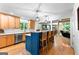 Bright, modern kitchen with hardwood floors, a blue island, and eat-in seating at 335 Winding Stream Trl, Hampton, GA 30228