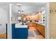Charming kitchen with oak cabinetry, blue island, stainless appliances, and hardwood floors at 335 Winding Stream Trl, Hampton, GA 30228