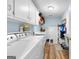 Functional laundry room with modern washer, dryer, and ample storage cabinets at 335 Winding Stream Trl, Hampton, GA 30228